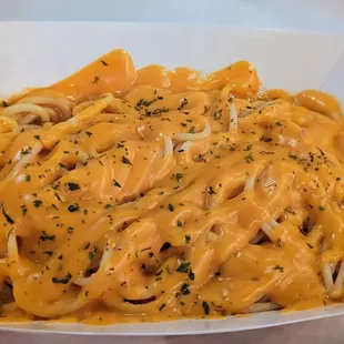 a plate of pasta with cheese sauce