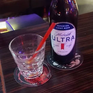 a bottle of beer and a glass on a table