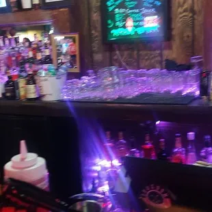 a view of a bar with purple lights