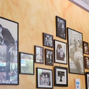 a wall full of framed photos