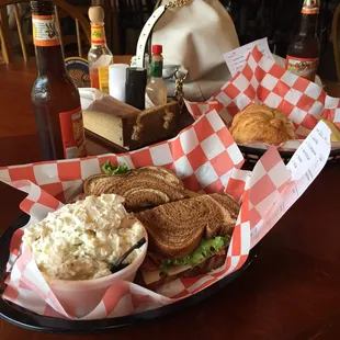 a tray of sandwiches and coleslaw