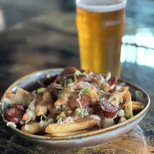 a plate of fries and a glass of beer