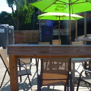 a patio with tables and umbrellas