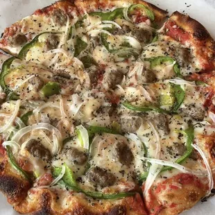 Chicago style pizza- fresh tomato sauce, Italian sausage, green peppers, onions and mozzarella cheese