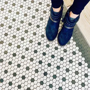 a person standing on a tiled floor