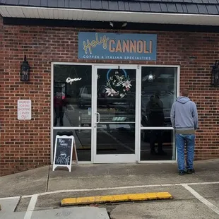 a man standing in front of a store
