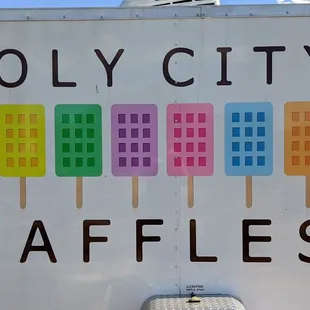 a sign for holy city waffles
