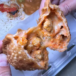 a hand holding a half eaten food item