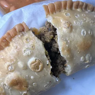 a portion of a meat and vegetable empanada