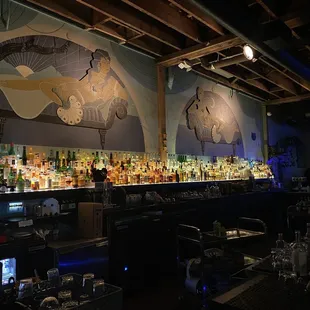 a bar with a lot of bottles of alcohol