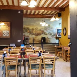 the dining area with a large painting on the wall