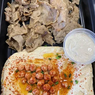 a meal of hummus, chicken, and hummus