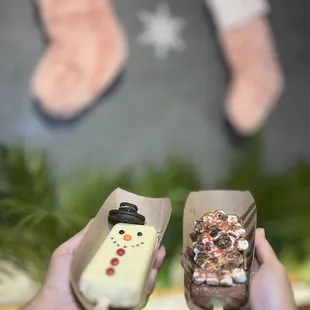 a person holding a remote control and a christmas stocking