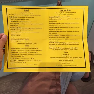 a person holding up a menu