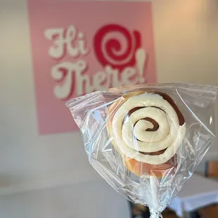 a hand holding a lollipop