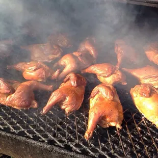 chickens cooking on a grill