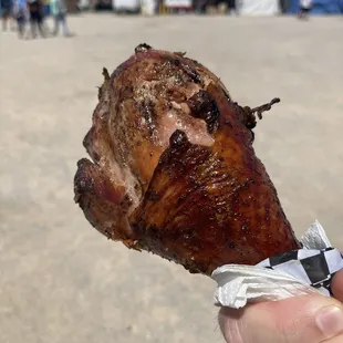 a hand holding a piece of meat