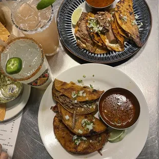 a plate of mexican food and a drink