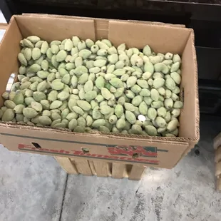 a box of green beans and oranges