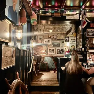 people sitting at tables in a pub