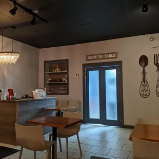 a dining area with tables and chairs