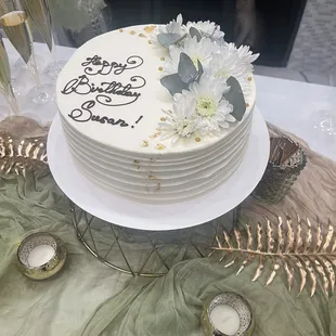 A gorgeous Honey Cake with flowers and edible gold leaf