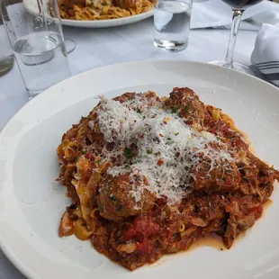 Fettuccini with neck bone gravy and meatballs.