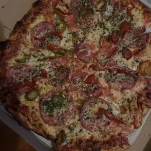 A one off special: NY style pizza, red sauce, sopressata,  pickled cherry peppers, garlic oil/parm crust
