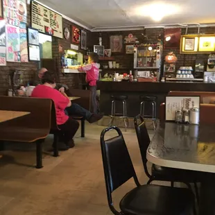 people sitting at tables in a restaurant