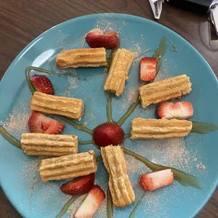 a plate of waffles and strawberries