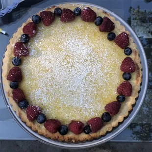 a pie with berries and powdered sugar