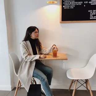 Two tables for two near the counter, under the menu