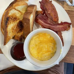 A la carte. Cheesy grits, bacon (i was only able to eat one bacon, thick and a good portion) and Challah toast.