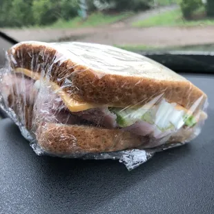 a sandwich wrapped in plastic