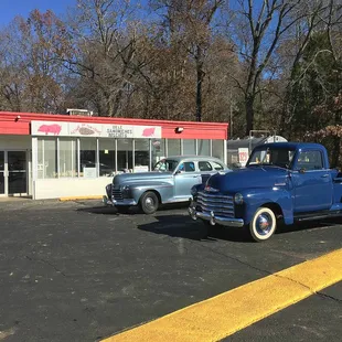 a blue truck parked in front of a store