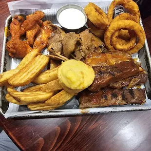 Sampler plate. Hot wings, onion rings , ribs  , brisket , potatoes wedges , Green chili muffin