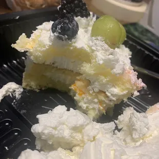 The layers of pound cake, fresh fruit and cool whip. Fruit cocktail in the middle