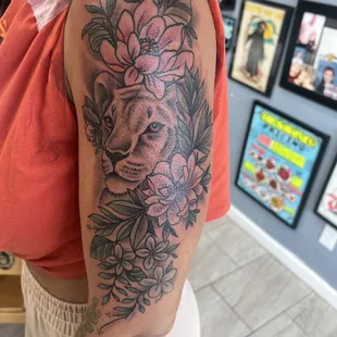 Lioness surrounded by foliage.