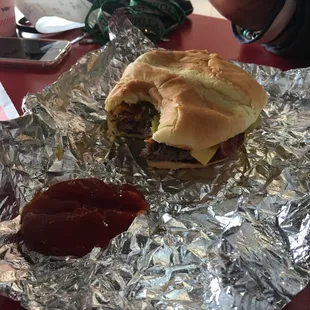 Bacon Single Cheese Burger with American cheese extra pickles and ketchup