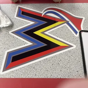 a person sitting at a table with a sign