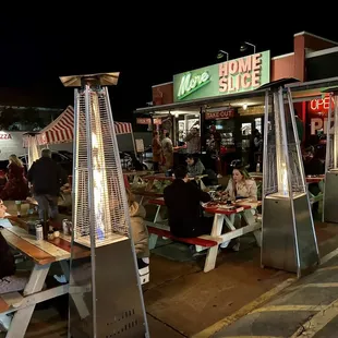 people sitting at picnic tables