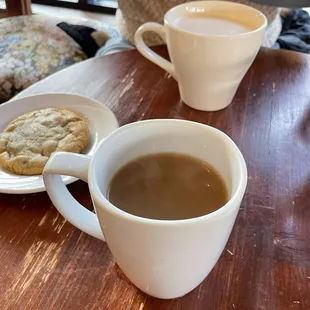 Back: chai latte. Middle: chocolate chip cookie. Front: earl grey tea with milk.