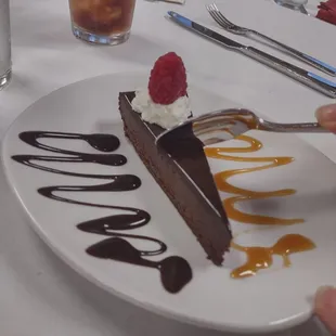 Flourless chocolate cake, very rich flavor and topped with sort of a ganache spread