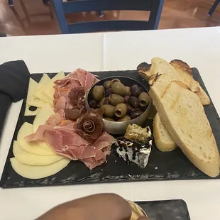 Goat cheese with balsamic and honey comb! Delicious variety of dried meats olives cheese and crostini! Delish