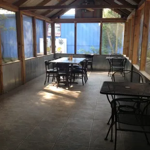tables and chairs in a sunroom