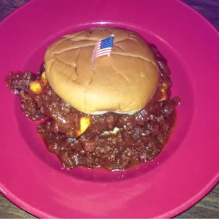 A thick juicy hamburger patty floating on homemade chili, smothered in melted cheese, and sweet slaw! Desert Storm Burger