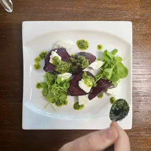Slow roasted beets that are then seared off and plated with goats milk feta, upland dress, and fresh chimichurri