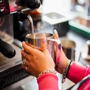 a woman pouring a cup of coffee