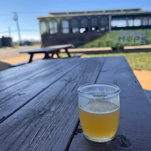 a glass of beer on a picnic table