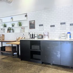 a kitchen with black cabinets and white tiles
